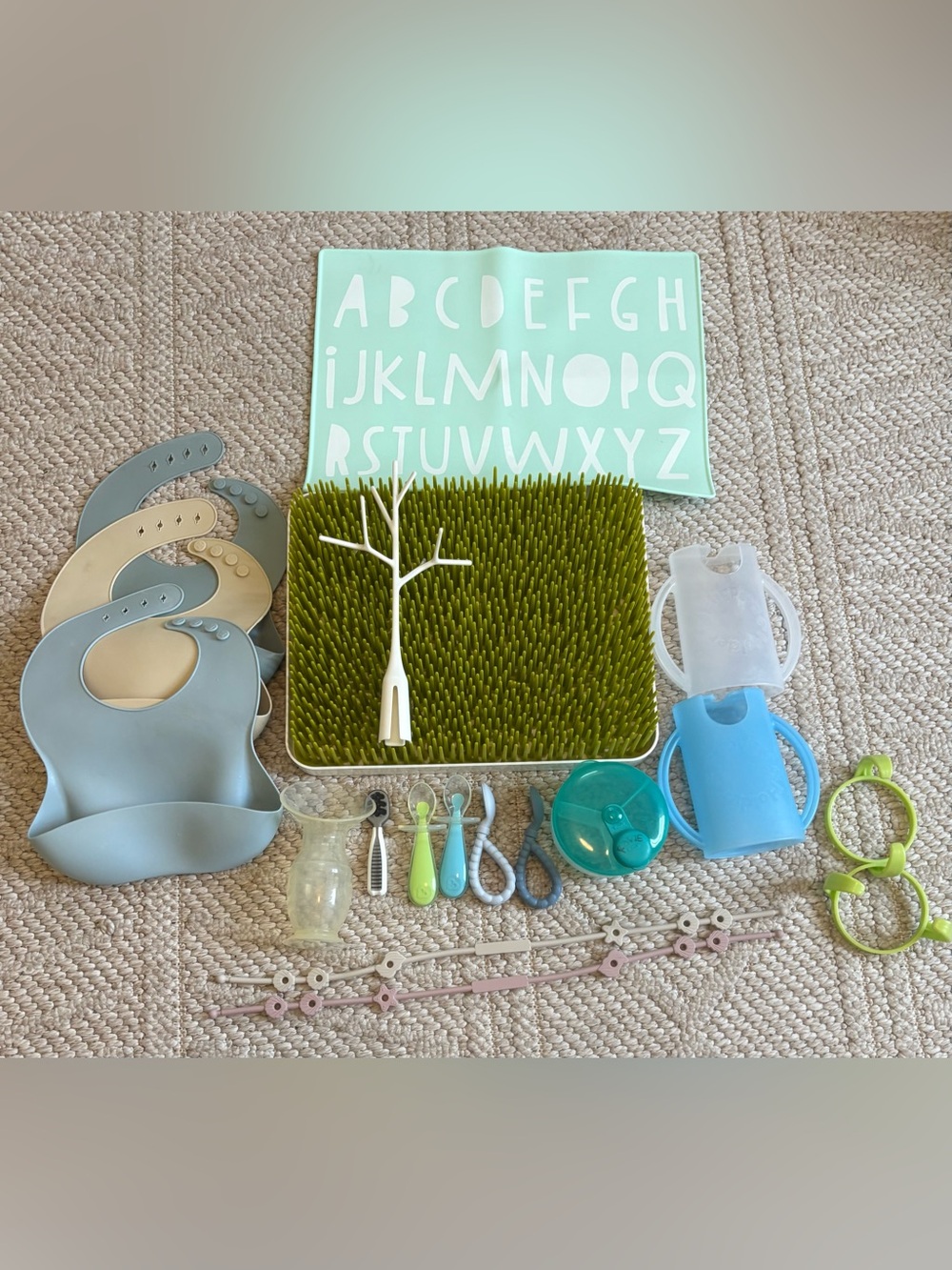 Boon drying grass, silicone bibs, itzy ritzy baby spoons, haakaa, pouch holder